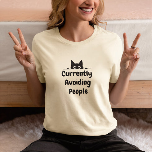 Currently Avoiding People graphic tee in soft cream – casual introvert humour shirt, perfect funny gift