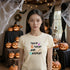 Soft Cream Halloween T-shirt with Trick Treat Nap Repeat slogan, styled for a relaxed post-trick-or-treat look